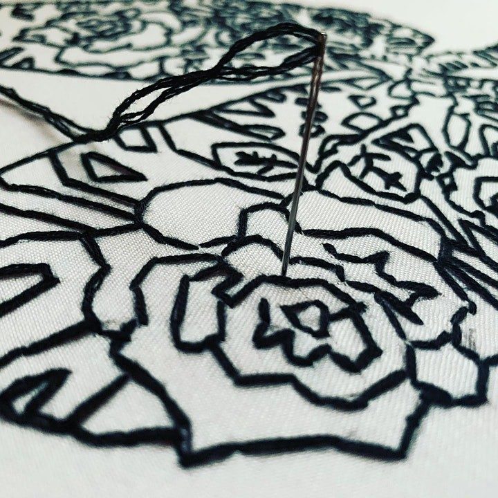 black and white embroidery in the shape of a flower